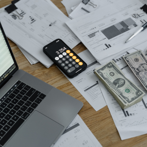 Financial workspace with calculator and documents